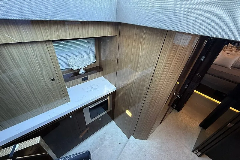 Slide: The Image of Luxurious interior of 2023 Cruisers Yachts 60 Fly with modern wood paneling and sleek design. - 14