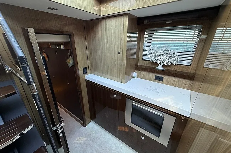 Slide: The Image of Luxurious interior of 2023 Cruisers Yachts 60 Fly with modern kitchen design. - 22