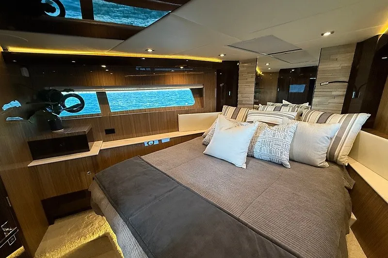 Slide: The Image of Luxurious bedroom interior of 2023 Cruisers Yachts 60 Fly with elegant wood finishes. - 20