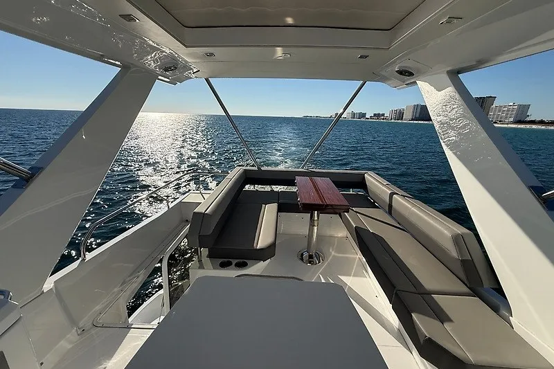 Slide: The Image of Luxurious 2023 Cruisers Yachts 60 Fly with spacious seating, overlooking serene ocean view. - 38