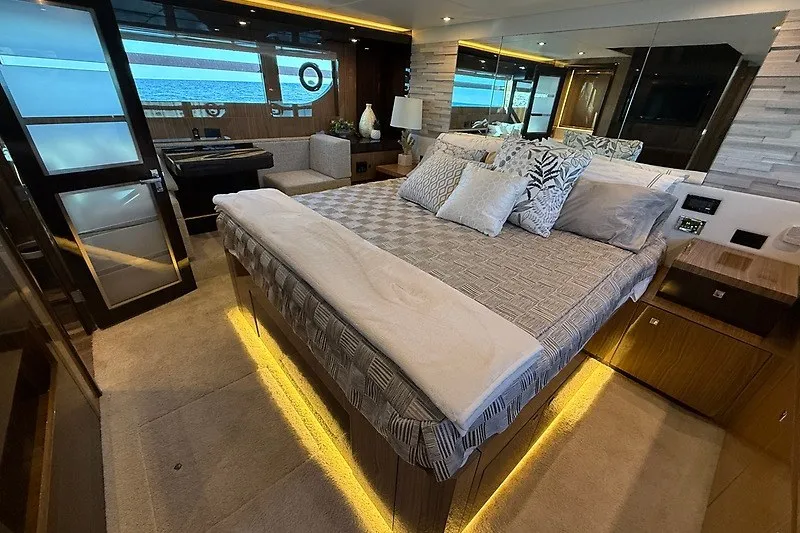 Slide: The Image of Luxurious bedroom interior of 2023 Cruisers Yachts 60 Fly with elegant bedding and ambient lighting. - 24