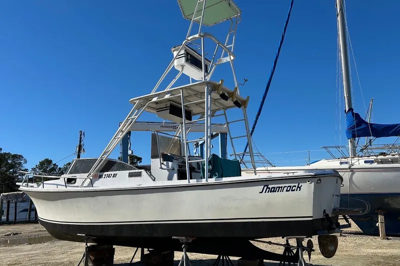 Slide: The Image of 1987 Shamrock 260 Stalker boat on dry dock under clear blue sky. - 2