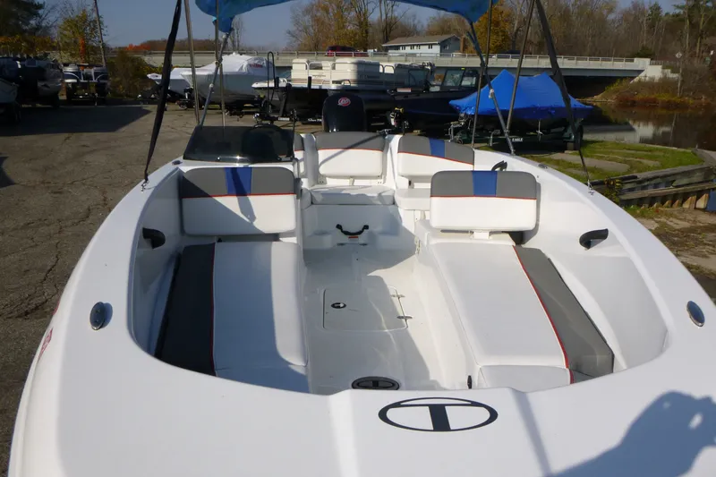 Slide: The Image of 2022 Tahoe T18 boat with seating, docked outdoors on a sunny day. - 16
