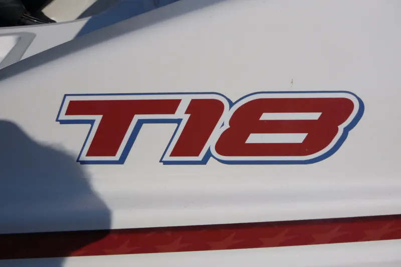 Slide: The Image of Close-up of 2022 Tahoe T18 logo on white surface. - 18