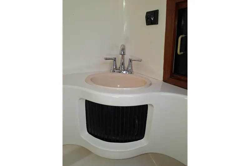 Slide: The Image of Bathroom sink in 1992 Luhrs Tournament 300 boat, featuring chrome faucet and compact design. - 31