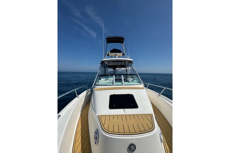 Slide: The Image of 1992 Luhrs Tournament 300 boat on open sea under clear blue sky. - 17