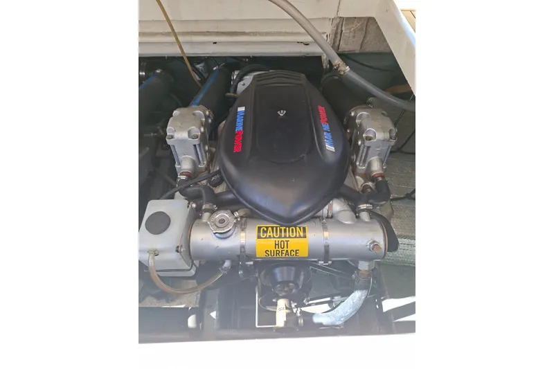 Slide: The Image of Engine of a 1992 Luhrs Tournament 300 boat with caution label. - 35