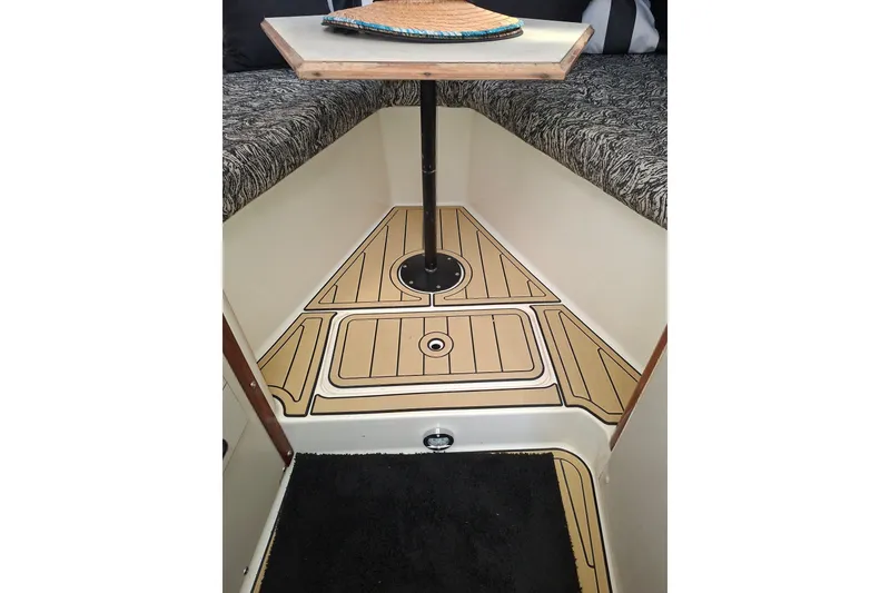 Slide: The Image of 1992 Luhrs Tournament 300 cabin interior with patterned seating and wooden flooring. - 20