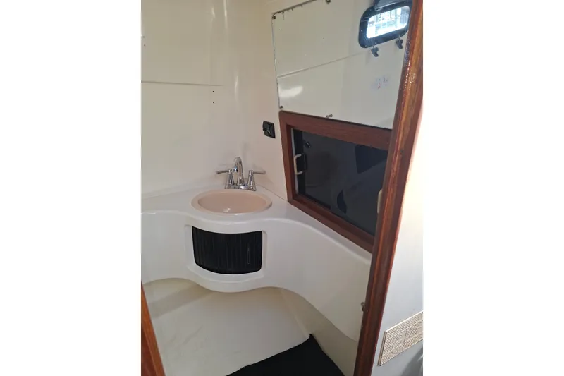 Slide: The Image of 1992 Luhrs Tournament 300 boat bathroom with sink and window. - 30