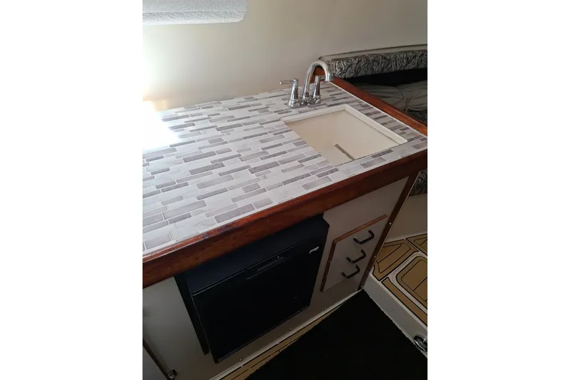 Slide: The Image of 1992 Luhrs Tournament 300 boat interior with tiled countertop and sink. - 24