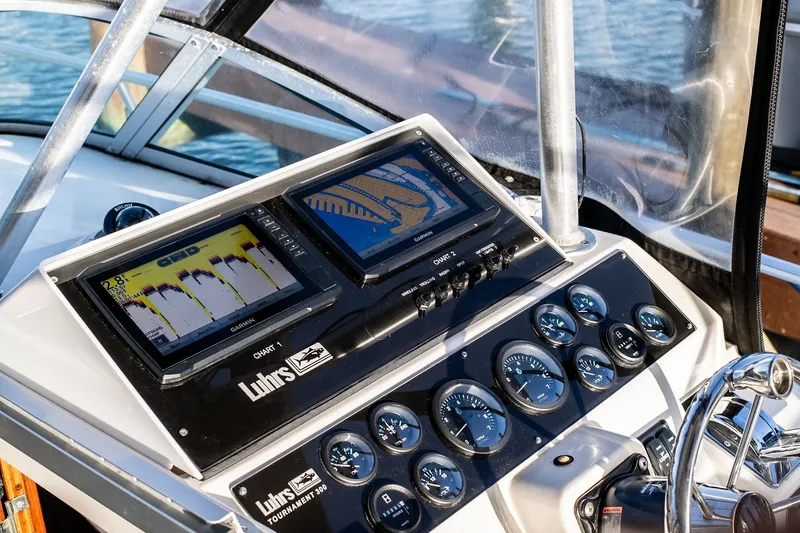 Slide: The Image of Control panel of a 1992 Luhrs Tournament 300 boat with navigation displays. - 16