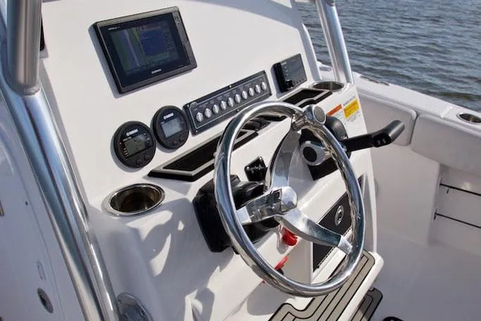 Slide: The Image of Manufacturer Provided Image: 2022 Sea Fox 228 Commander boat dashboard with steering wheel and navigation controls. - 12