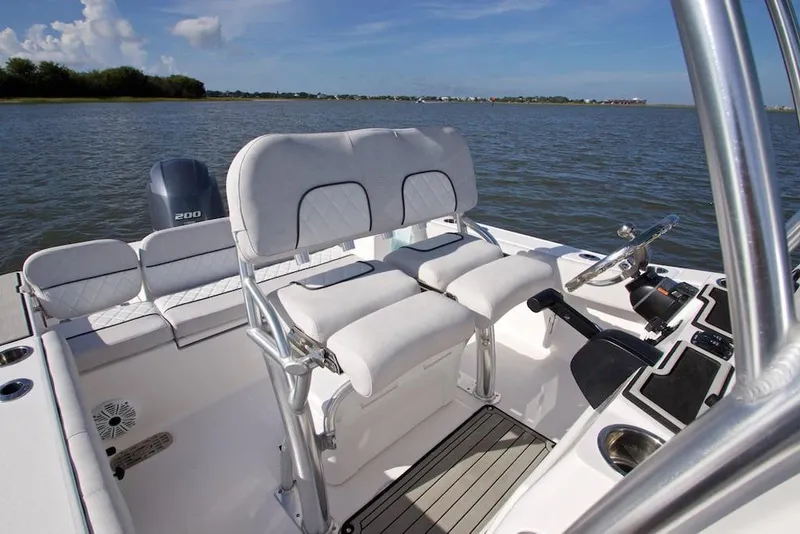 Slide: The Image of Manufacturer Provided Image: 2022 Sea Fox 228 Commander boat interior with dual seats and steering console on calm water. - 13