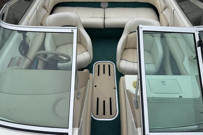 Slide: The Image of 1996 Sea Ray 190 Bow Rider interior with beige seating and green carpet. - 14