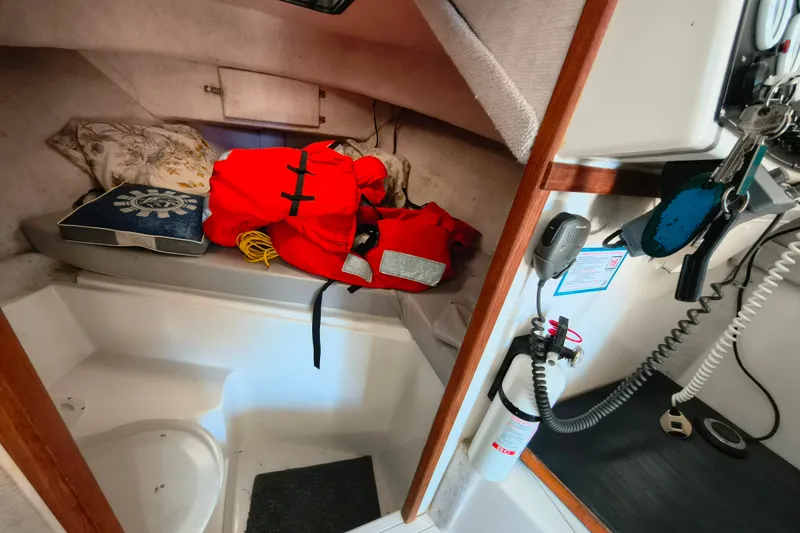 Slide: The Image of Interior of a 2004 Osprey 26 Fisherman boat with life jacket and safety equipment. - 15