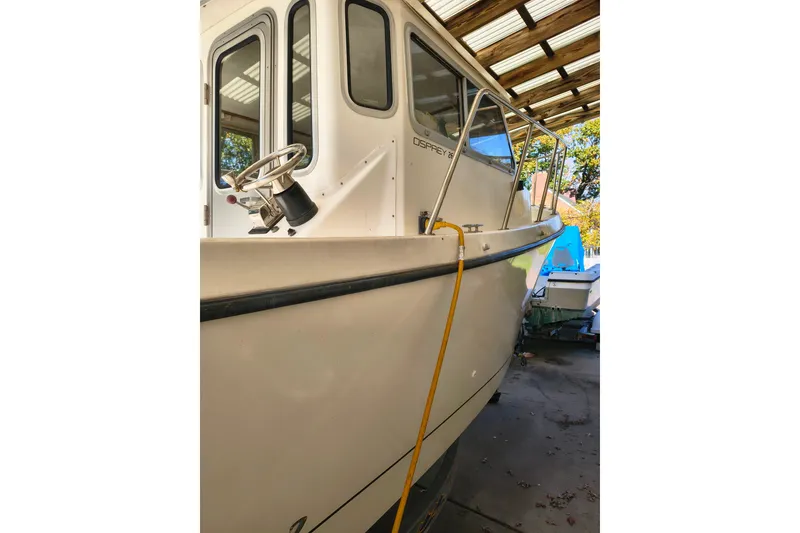 Slide: The Image of 2004 Osprey 26 Fisherman boat docked under a shelter. - 17