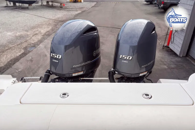 Slide: The Image of Twin Yamaha 150 outboard engines on a 2019 Robalo R247 Dual Console boat. - 11