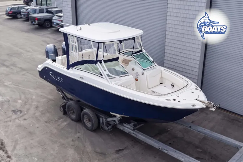 The Image of 2019 Robalo R247 Dual Console boat on trailer, parked outdoors. - 0