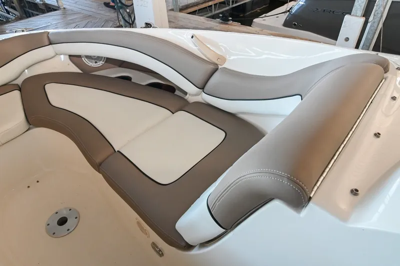 Slide: The Image of Luxurious seating on a 2001 Sea Ray 290 Select EX boat, featuring beige and white upholstery. - 11