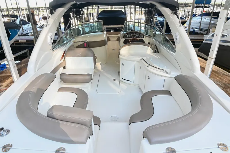 Slide: The Image of 2001 Sea Ray 290 Select EX boat interior with spacious seating and modern dashboard. - 3