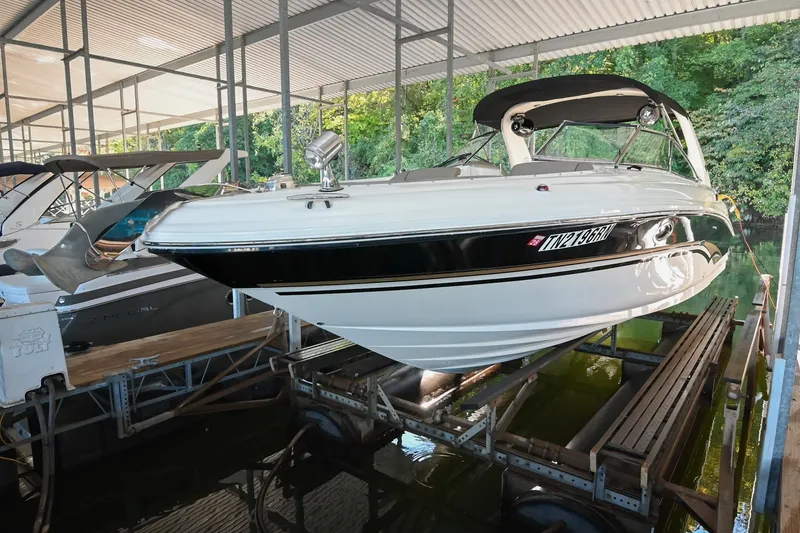 The Image of 2001 Sea Ray 290 Select EX boat docked in a covered marina. - 1