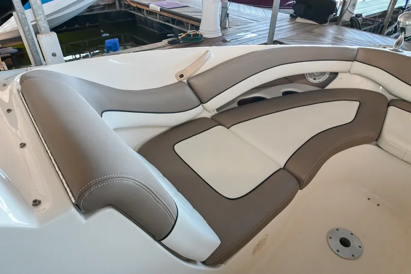 Slide: The Image of Luxurious seating on a 2001 Sea Ray 290 Select EX boat, featuring beige and white upholstery. - 10