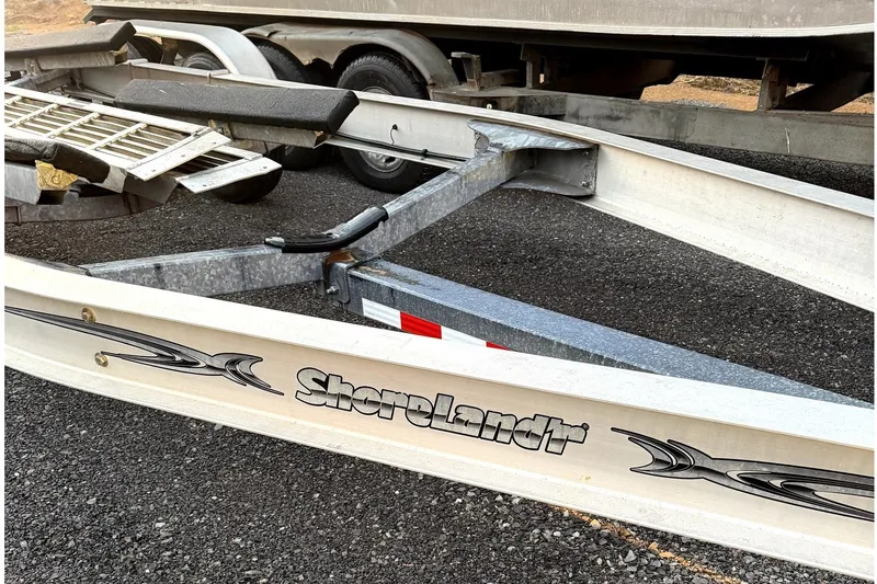 Slide: The Image of A Shoreland'r boat trailer on an asphalt surface. - 14