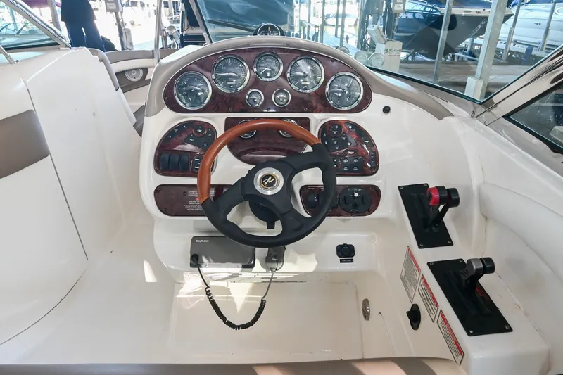 Slide: The Image of Cockpit of 2001 Sea Ray 290 Select EX boat with steering wheel and control panel. - 8