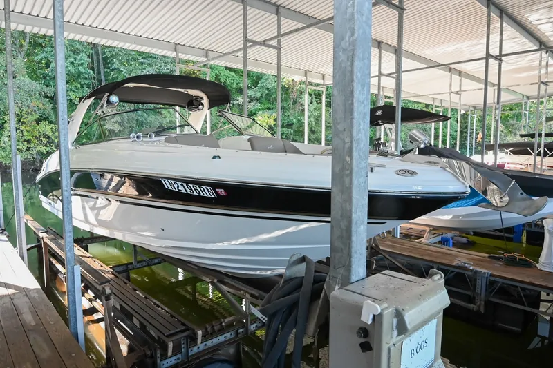 Slide: The Image of 2001 Sea Ray 290 Select EX boat docked under a covered marina. - 0