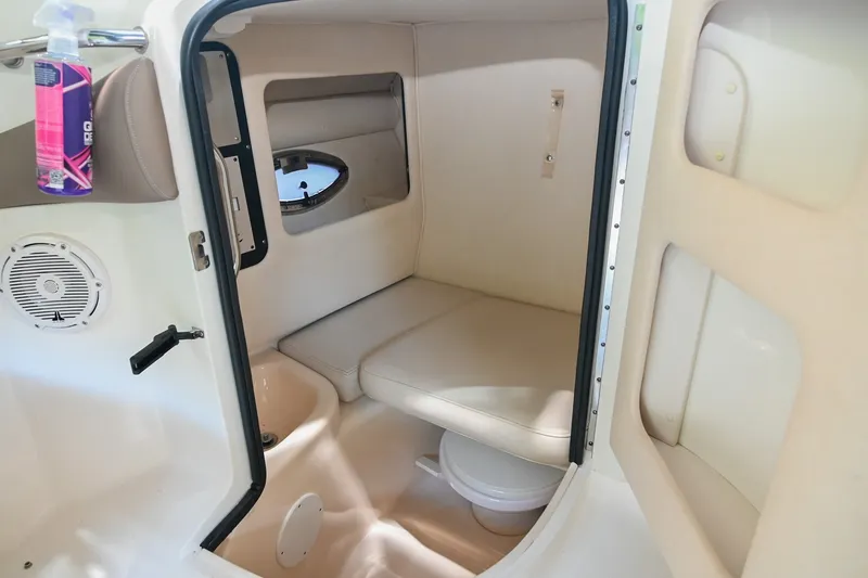 Slide: The Image of Interior cabin of 2001 Sea Ray 290 Select EX boat, featuring seating and a small window. - 7
