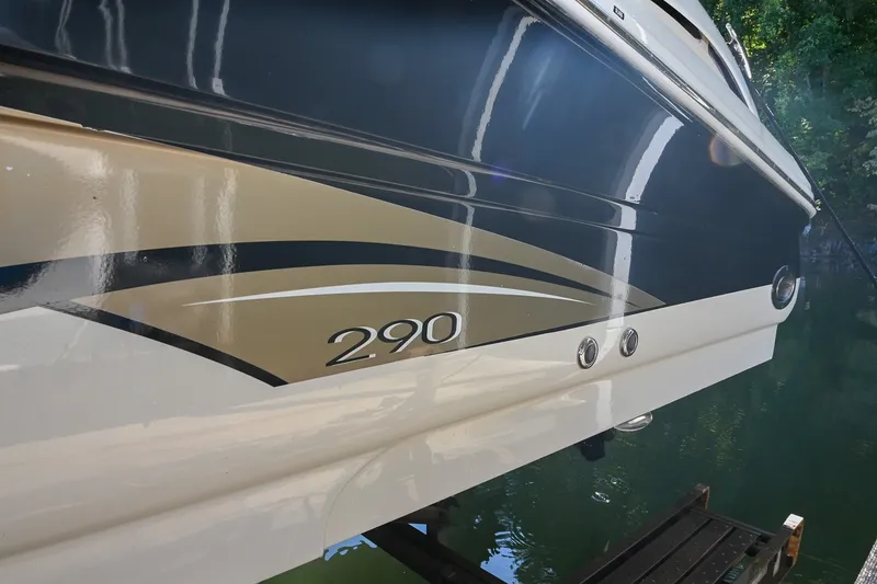 Slide: The Image of 2001 Sea Ray 290 Select EX boat with sleek design and water reflection. - 2