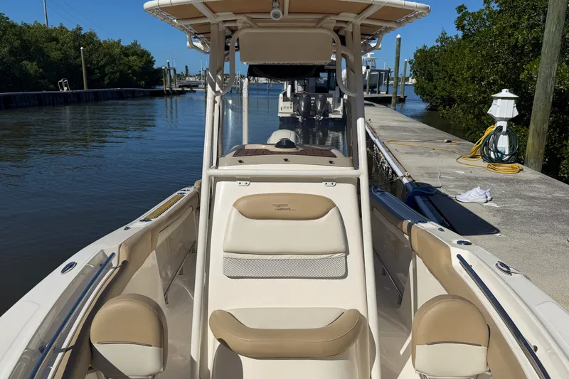 Slide: The Image of 2022 Pioneer 202 Islander boat docked by a calm waterway. - 16