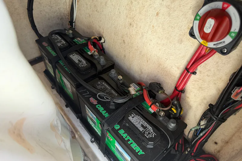 Slide: The Image of Battery compartment of 2022 Pioneer 202 Islander boat with wiring and switch. - 18
