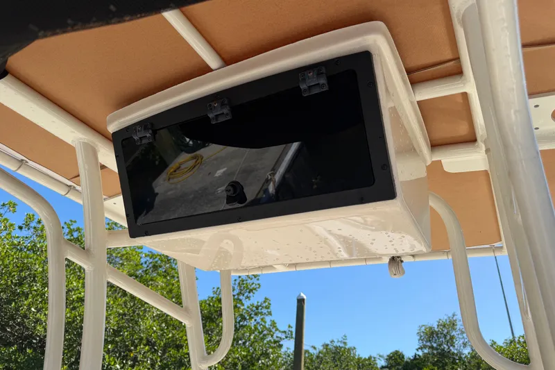 Slide: The Image of 2022 Pioneer 202 Islander boat T-top with storage compartment, sunny day. - 15