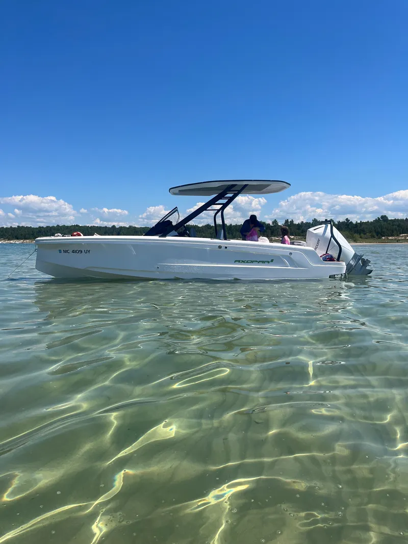 The Image of An Axopar 22 T-Top boat from 2022 on clear water with a blue sky in the background. - 0