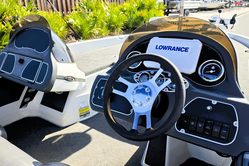 Slide: The Image of 2009 Ranger 208 VX boat dashboard with steering wheel and Lowrance navigation system. - 2