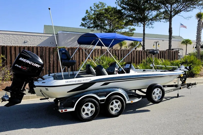 Slide: The Image of 2009 Ranger 208 VX boat with Mercury engine on trailer, parked outdoors. - 9