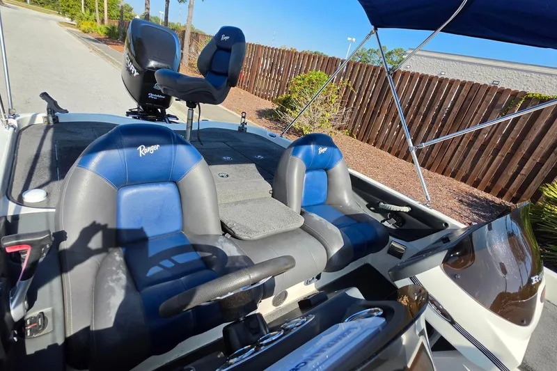 Slide: The Image of 2009 Ranger 208 VX boat interior with blue and gray seats, steering wheel, and canopy. - 5