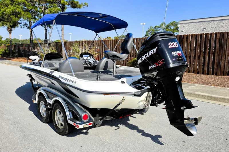 Slide: The Image of 2009 Ranger 208 VX boat with Mercury 225 Pro XS engine, parked outdoors. - 15