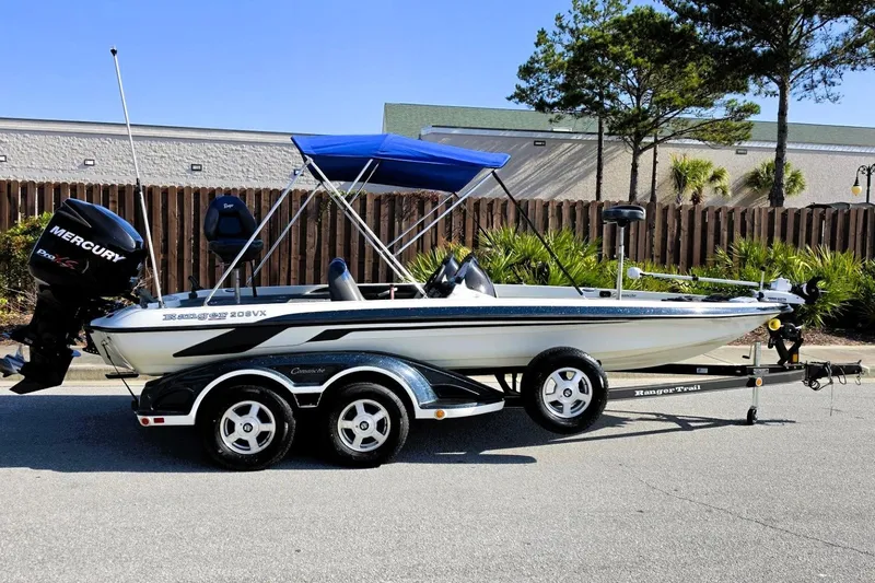 Slide: The Image of 2009 Ranger 208 VX boat with Mercury engine on trailer, parked outdoors. - 8