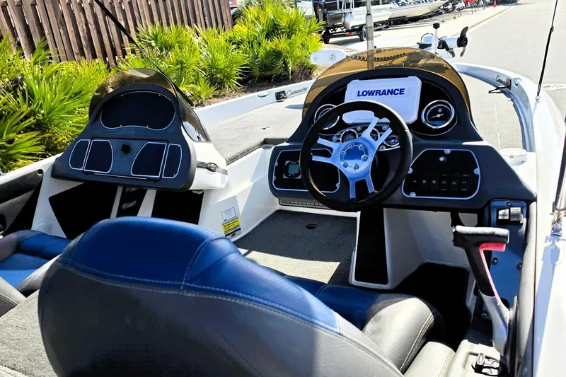 Slide: The Image of Interior of a 2009 Ranger 208 VX boat with steering wheel and control panel. - 3