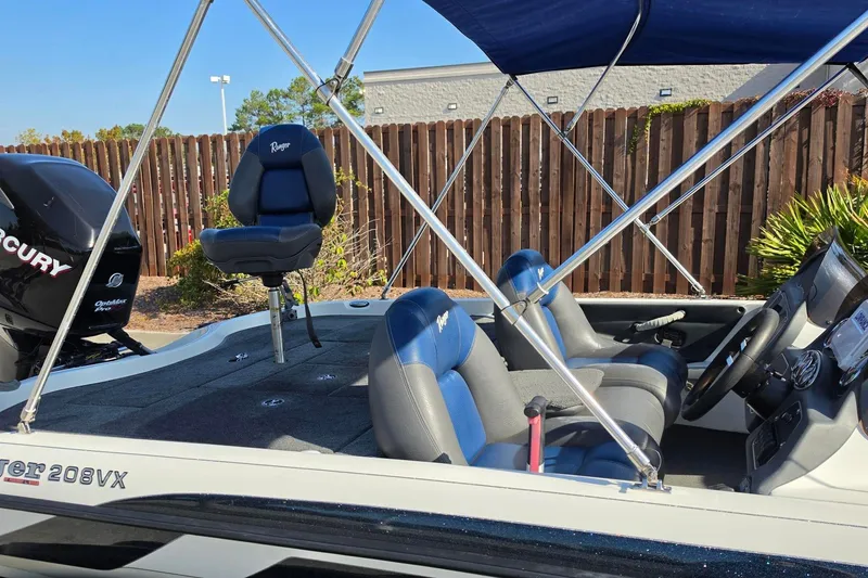 Slide: The Image of 2009 Ranger 208 VX boat interior with seating and Mercury outboard motor. - 6