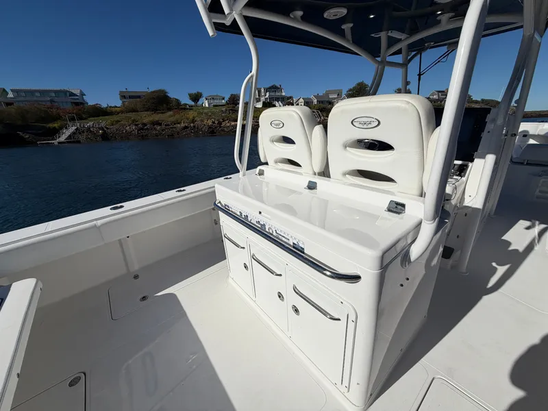 Slide: The Image of The image shows the cockpit of a 2016 Southport 33 FE boat with white seats. - 19