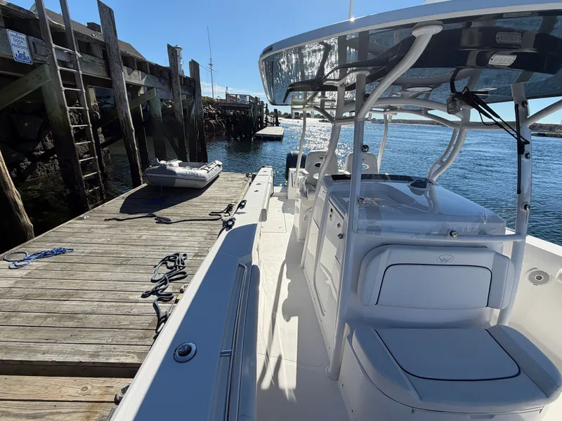 Slide: The Image of A 2016 Southport 33 FE docked at a wooden pier. The boat features a modern design. - 7