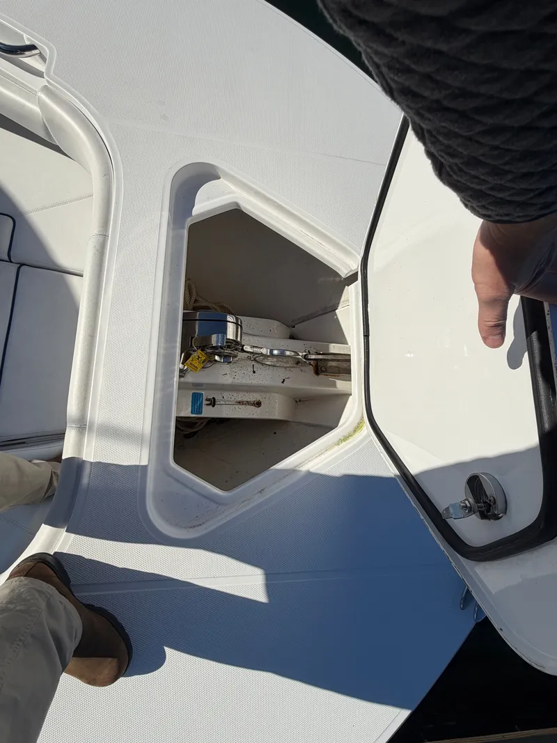 Slide: The Image of An open storage compartment on a boat with visible anchor and rope. - 9