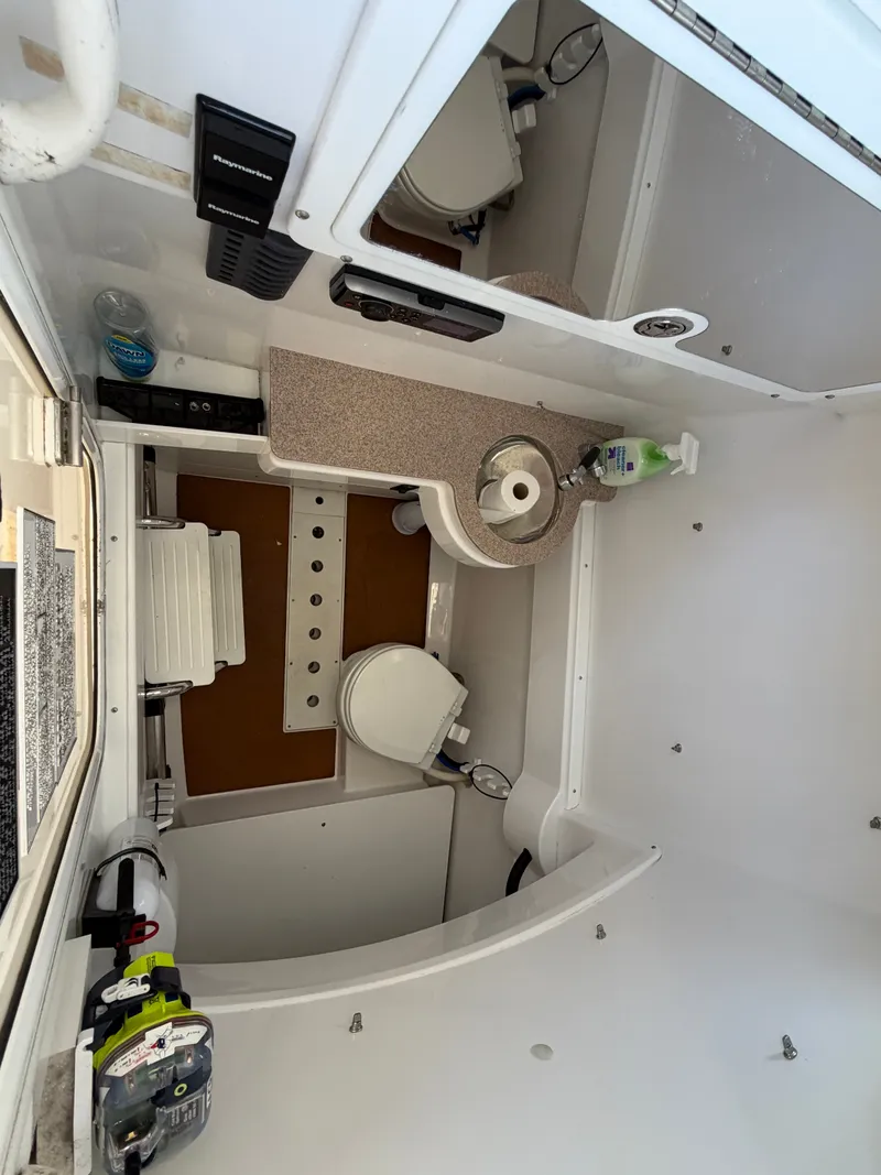 Slide: The Image of Interior of a 2016 Southport 33 FE with sink, toilet, and storage space. - 22