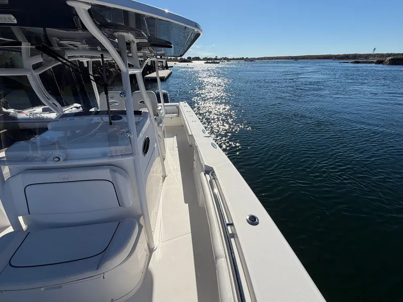Slide: The Image of A 2016 Southport 33 FE on calm water, with a clear view of the deck and railing. - 8