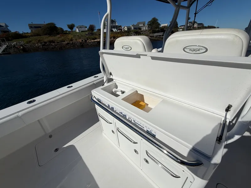 Slide: The Image of The image shows the cockpit of a 2016 Southport 33 FE boat with storage and seating. - 18