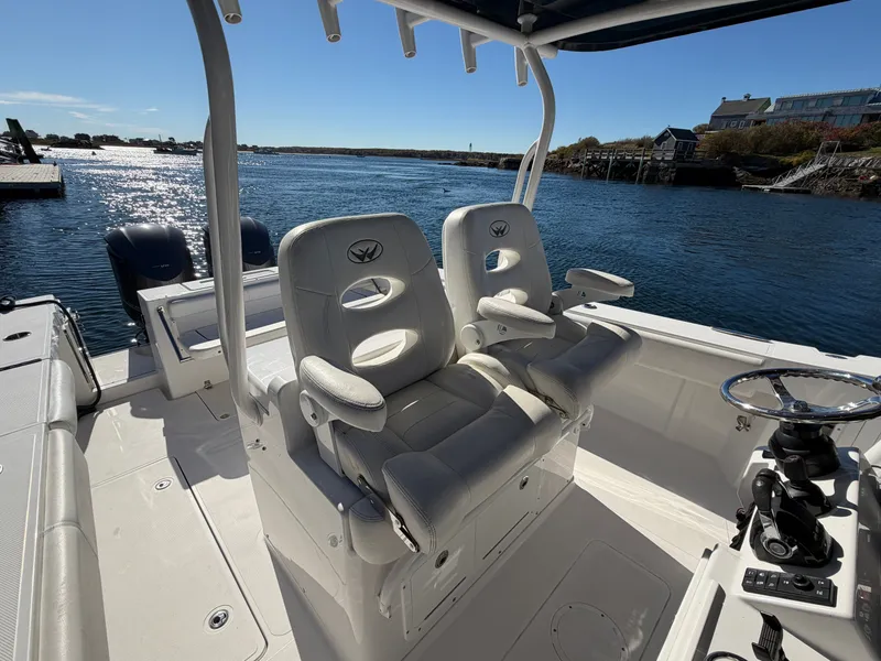 Slide: The Image of The image shows the cockpit of a 2016 Southport 33 FE boat with two white seats. - 13