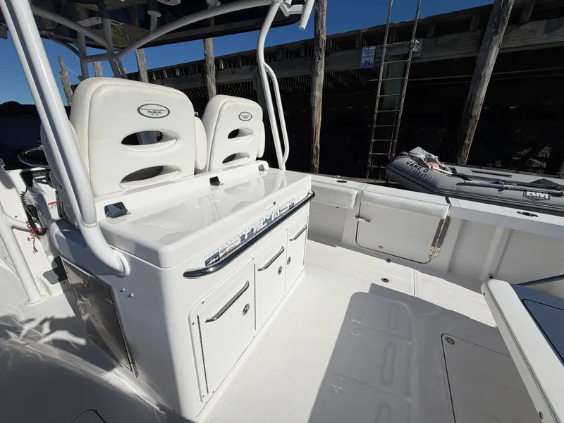 Slide: The Image of The image shows the cockpit of a 2016 Southport 33 FE boat with white seats. - 20